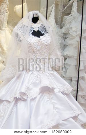white wedding dress gown on mannequin in bridal gown. Bride's morning wedding preparation concept