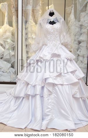 white wedding dress gown on mannequin in bridal gown. Bride's morning wedding preparation concept