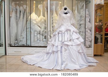 white wedding dress gown on mannequin in bridal gown. Bride's morning wedding preparation concept