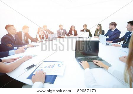 business partners gathered round the table and prepared to discu
