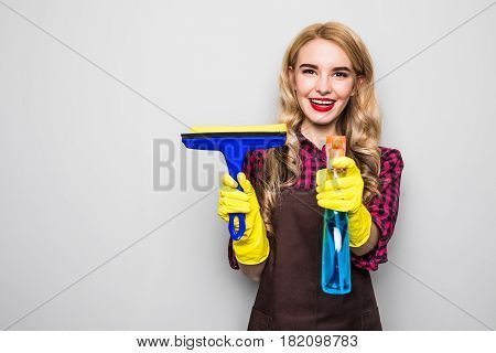 Portrait Of Attractive Young Woman Cleaning Windows Isolated On Grey