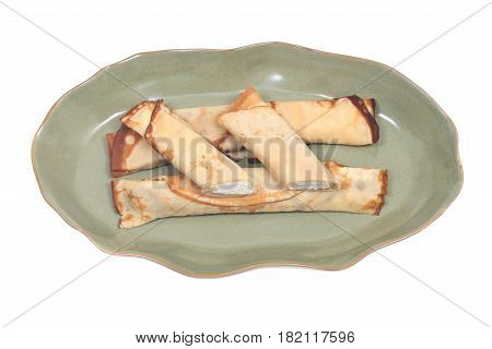 Delicious cheese blintz on green plate isolated on white background