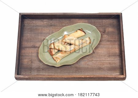 Delicious cheese blintz on green plate and wooden vintage tray