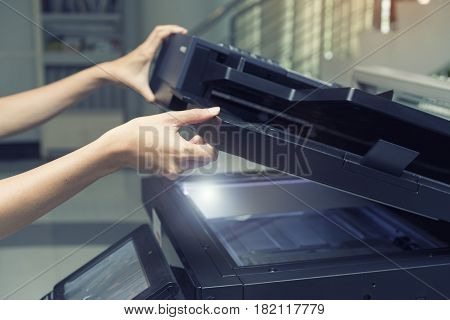 woman opening a copying device, close up
