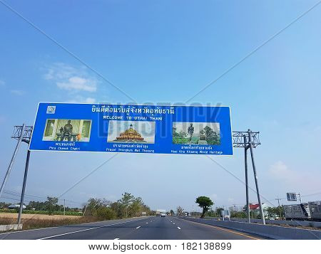 UTHAI THANI THAILAND - MARCH 31 : directional traffic sign on highway Welcome to Uthai Thani province with clear blue sky on March 31 2017 in Uthai Thani Thailand.