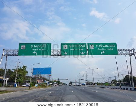 UTHAI THANI THAILAND - MARCH 31 : directional traffic sign to Phayuha Khiri Ban Noen Makok and Nakhon Sawan on March 31 2017 in Uthai Thani Thailand.