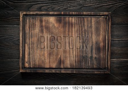 Food background. Cutting board on dark wooden table. Copy space.