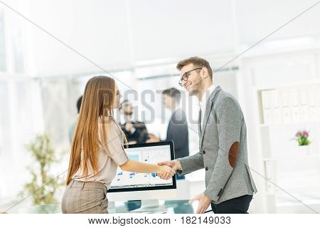 handshake between lawyer and client after reviewing the investment plan for development of the company.the photo has a empty space for your text.