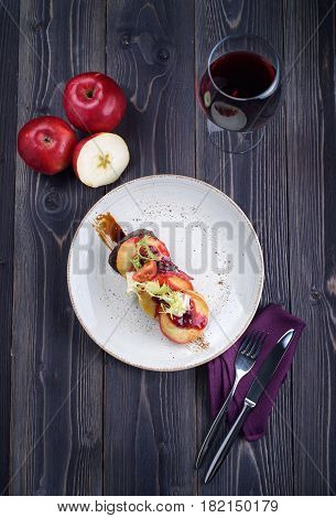 Goose liver with cherry sauce and apples and a glass of wine