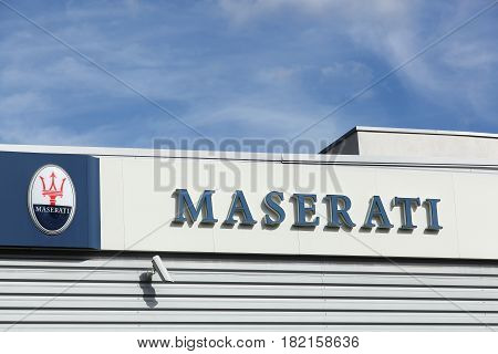 Lyon, France - September 25, 2015: Maserati logo on a wall. Maserati is an Italian luxury vehicle manufacturer established on 1 December 1914, in Bologna