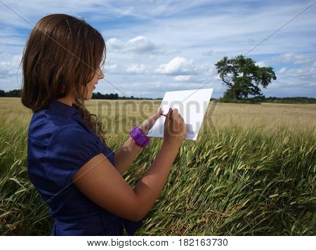 girl in a field like drawing a tree
