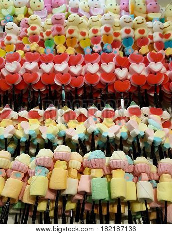 Colorful jelly candy stick on fabric and background .