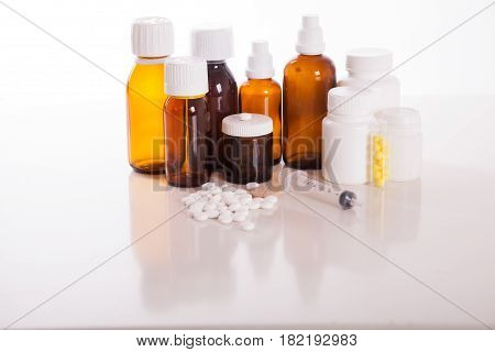 Composition of medicine bottles and pills isolated on white.