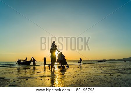 Ao Nang Krabi Thailand - March 02 2017: People on the Ao Nang beach at sunset in Krabi province Thailand