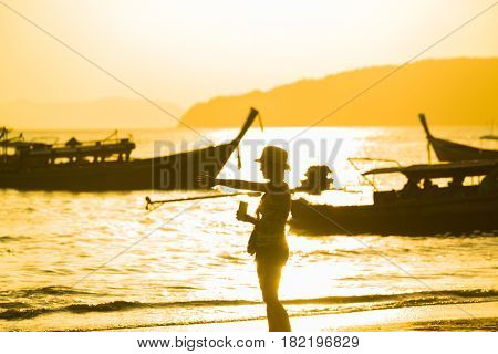 Ao Nang Krabi Thailand - March 02 2017: People on the Ao Nang beach at sunset in Krabi province Thailand
