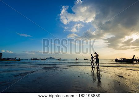 Ao Nang Krabi Thailand - March 02 2017: People on the Ao Nang beach at sunset in Krabi province Thailand