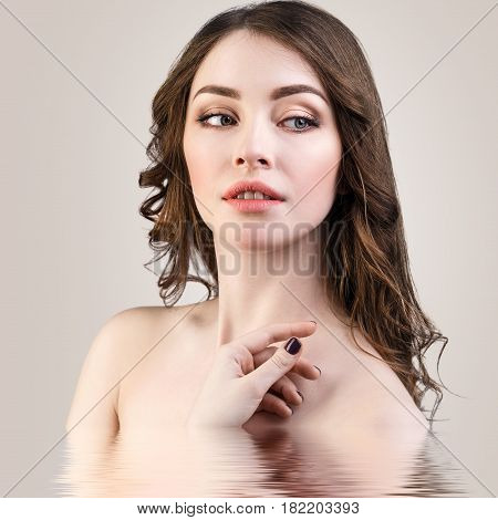Young beautiful woman with reflection on water surface