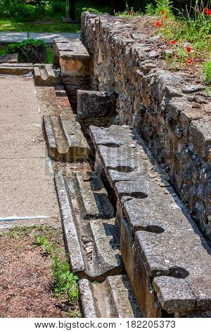 Ancient public toilets along the central road in Dion archaeological park, Pieria, Greece.