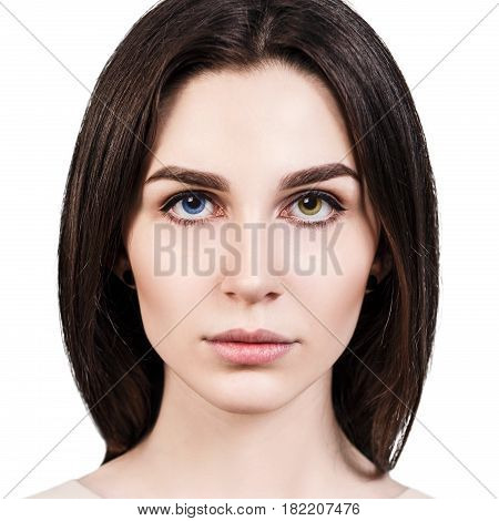 Portrait of young beautiful girl with heterochromia over white background