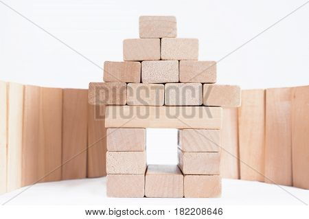 A house with a fence made of wooden blocks