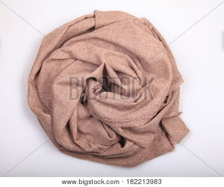 Light brown linen and cashmere scarf on white background scarf top view .