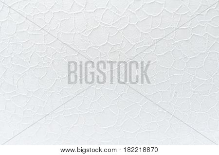 White lace guipure cloth background with floral pattern. Selective focus