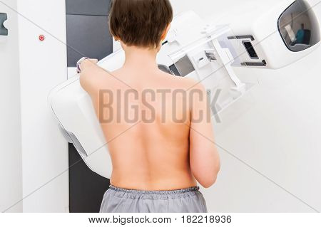 Female Patient Undergoing Mammography Test In Hospital.backview, Selective Focus
