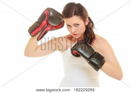 Violence in relationship concept. Dominant bide wearing wedding dress and boxing gloves
