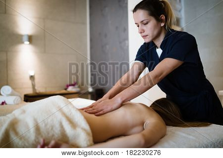 Masseur treating patient with therapeutic massage treatment