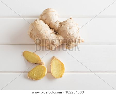 the ginger on a white wooden background