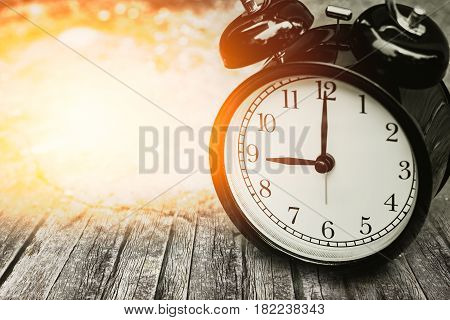 Old Memory Time Concept, Retro Clock Timed At 9 O'clock On Wood With Sun Light.