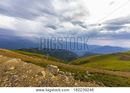 Beautiful mountainscape with cloudy sky and cableway on foreground