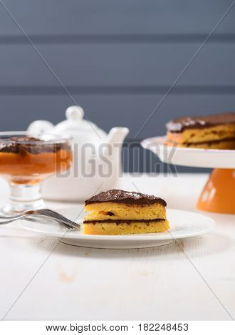 White faience teaware low callorie pumpkin dessert and layered pumpkin cake with chocolate ganache with copy space