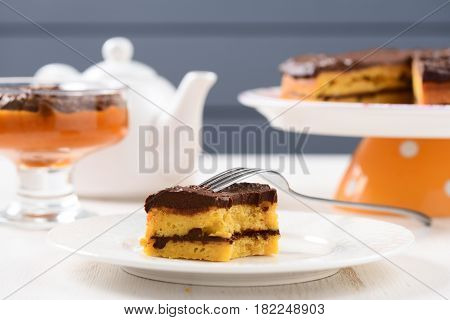 Tea table with teaware low callorie pumpkin dessert and homemade layered pumpkin cake with chocolate ganache horizontal