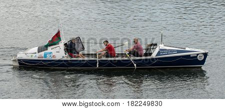 CARDIFF UK - APRIL 14 2017. Talisker Whiskey Atlantic Challenge boat with crew. Rowers and coach training for Atlantic crossing on board ocean-going rowing boat on lake in Cardiff Bay Wales