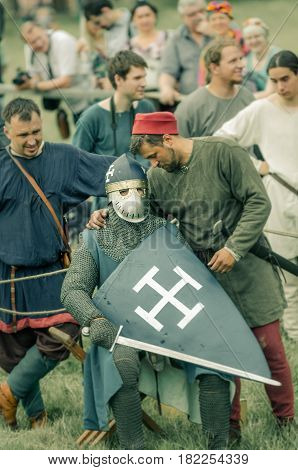 RITTER WEG MOROZOVO APRIL 2017: Festival of the European Middle Ages. Medieval joust knights in helmets and chain mail battle on swords with shields in their hands.