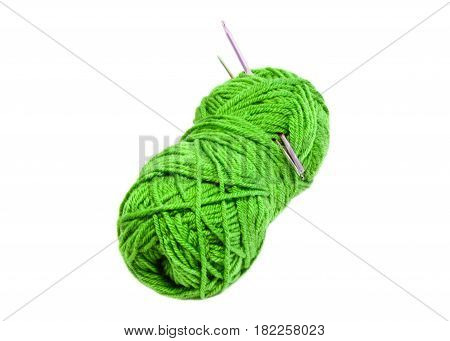 Green yarn clew with crochet hooks isolated on white background