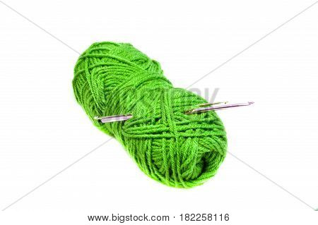 Green yarn clew with crochet hooks isolated on white background