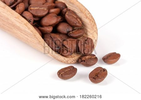 coffee beans in a wooden scoop isolated on white background.