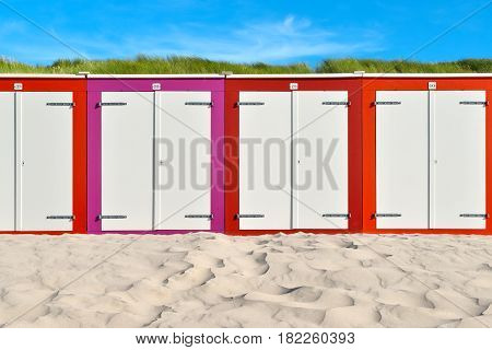 On the Beach by the Sea - beautiful colorful beach huts on a sandy beach on a sunny day