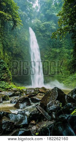 Amazing Nungnung waterfall, Huge Rocks in front, Bali Indonesia