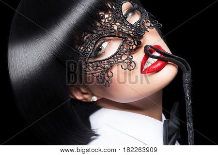Sexy woman in mask whip on red lips bdsm isolated on black