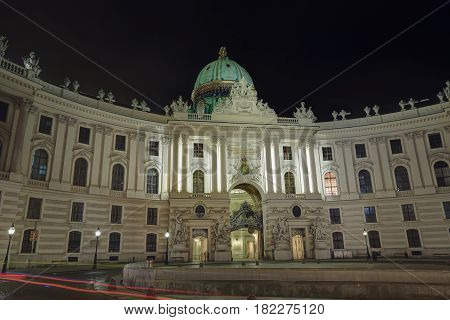 The building of the St. Michael wing (Michaelertrakt) of the Hofburg Palace with night illumination. Vienna, Austria