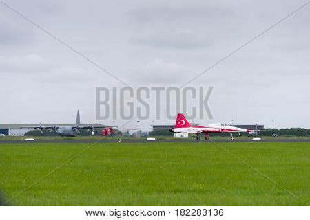 LEEUWARDEN NETHERLANDS - JUNE 10 2016: One of the NF-5 Canadair fighter planes of Turkish Star aerobatic demonstration team is landing with a parachute