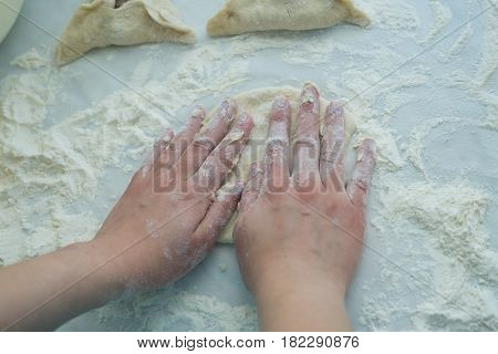 Preparing dough. Baking peremech concept. Flour, dough and meat cooking ingredients. Hands top view of cooking belyash cuisines