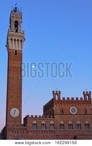 The Moon behind Torre del Mangia and Palazzo Publico - Siena, Italy