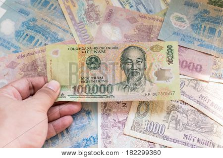 100,000 dong of Vietnamese banknote on Vietnamese banknote background.