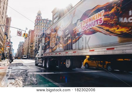 New York Usa - March 20 2017 : Dunkin' Donuts truck is crossing street at downtown manhattan.