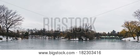 Central Park Boathouse and iced lake in New York City USA. Panoramic view.