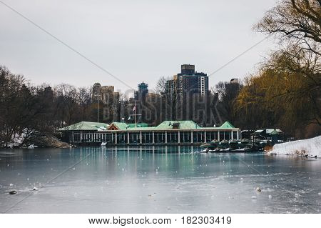 Central Park Boathouse and iced lake in New York City USA